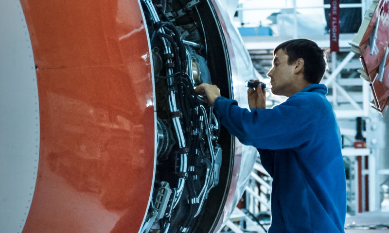 man fixing an airplane